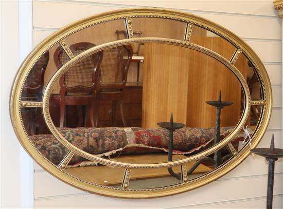 A 19th century gilt oval Adams style wall mirror W.110cm